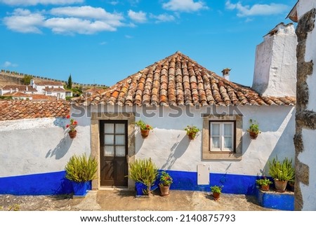 Facade of small stone house in medieval Obidos, Portugal