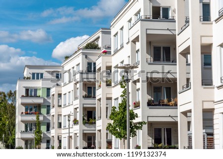 The facade of some white modern apartment buidlings seen in Berlin, Germany
