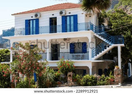 Facade and terrace of white colour tripical country house closeup, vacation and relax