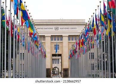 Facade of United Nations (UN) Palace at City of Geneva with nation flags in a row on a cloudy spring day. Photo taken March 18th, 2022, Geneva, Switzerland.