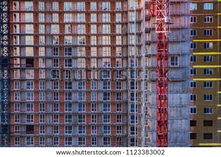a facadeof a tallbuilding with lots of similar windows next toeach other