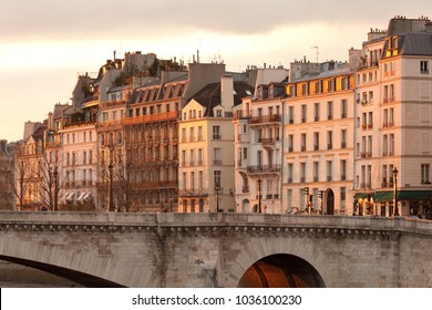 Facades Of Apartment Buildings At Ile Saint Louis And Pont De La Tournelle Bridge, Paris, France