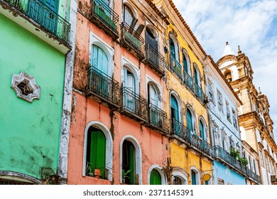 Facades of colorful houses and church in baroque and colonial style damaged by time in the Pelourinho neighborhood in the city of Salvador