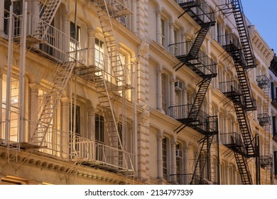 Facades Of Soho Loft Buildings With Fire Escapes At Dusk. Lower Manhattan, New York City