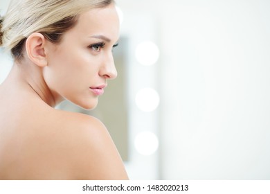 Face Of Ageless Woman With No Wrinkles On Her Face Looking Away