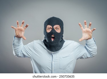 Face of a angry burglar wearing a black ski mask or balaclava 