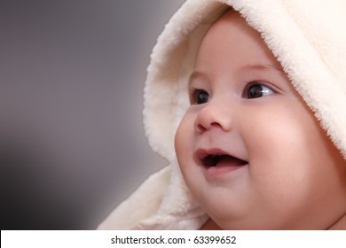 Face Of A Baby With A Blanket Over His Head, Smiling