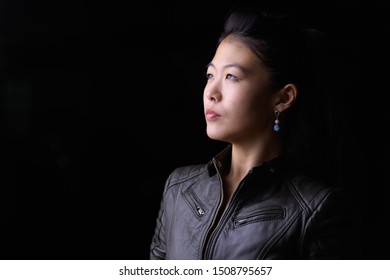 Face Of Beautiful Asian Rebellious Woman Thinking Outdoors At Night