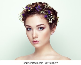 Face Of Beautiful Woman Decorated With Flowers. Perfect Makeup. Beauty Fashion. Eyelashes. Cosmetic Eyeshadow