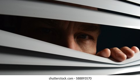 Face behind blinds