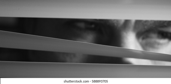 Face behind blinds
