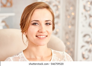 
face blonde happy bride before the wedding.
Portrait of a young girl with a beautiful smile. The bride smiles. Beautiful teeth.