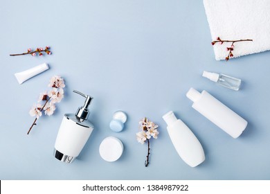 Face And Body Care Products With Spring Bloom (tonic Or Lotion, Serum, Cream, Shampoo, Micellar Water, Cotton Pads And Sticks, Shaver) On Blue. Freshness And Body Care. Skin Cosmetics. Border Banner