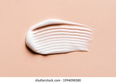 Face Or Body Cream Hair Balm Swatch On Nude Background, Close Up. Stroke Of Cosmetic Product.