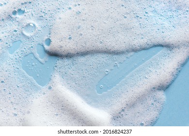Face cleansing mousse sample. White cleanser foam bubbles on blue background. Soap, shower gel, shampoo foam texture closeup. - Shutterstock ID 2016824237