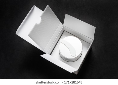Face cream jar with plastic scoop in whire carton box, package