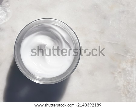 Face cream moisturiser, glass jar on marble stone background, skincare and cosmetic, beauty product concept