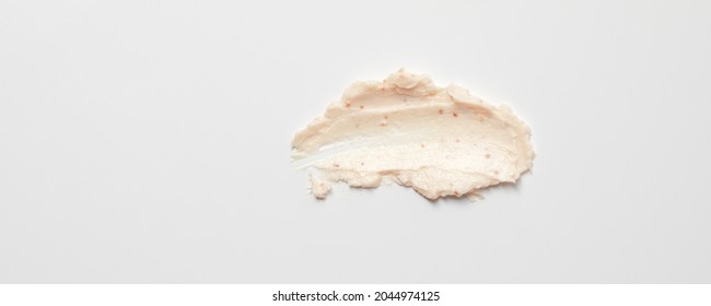 Face Cream Scrub Texture Background. Exfoliating Skin Care Product Swatch Smear Smudge. Gentle Creamy Scrub Cleanser Sample Close Up