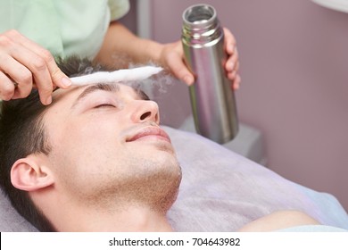 Face cryomassage, caucasian man. Skin cryotherapy close up. Liquid nitrogen use in medicine.