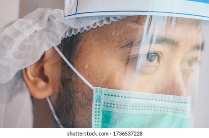 Face Of Doctor Having Tired From Work While Wearing PPE Suit For Protect Coronavirus Disease. The Wellbeing And Emotional Resilience Are Key Components Of Maintaining Essential Care Services.