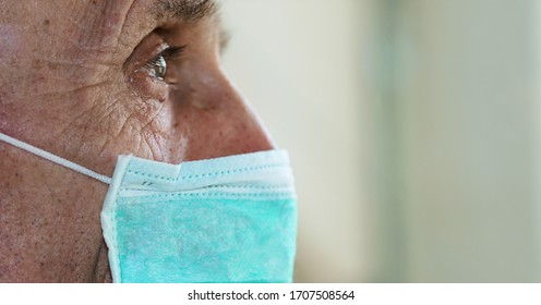 face of elderly man wearing medical facemask health safety concept
