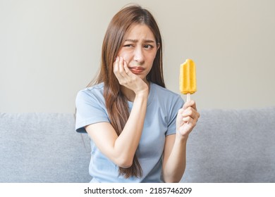 Face Expression Suffering From Sensitive Teeth And Cold, Asian Young Woman, Girl Feeling Hurt, Pain Eating Ice Cream, Lolly. Toothache Molar Tooth At Home, Dental Problem Isolated On White Background.