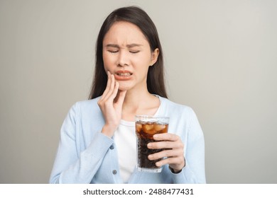 Face expression suffering from sensitive teeth, Asian young woman touching cheek