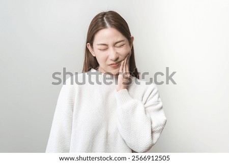 Face expression suffering from sensitive teeth and cold, asian young woman, girl feeling hurt, pain touching cheek, mouth with hand. Toothache molar tooth, dental problem isolated on white background.