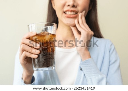 Face expression suffering from sensitive teeth, Asian young woman touching cheek