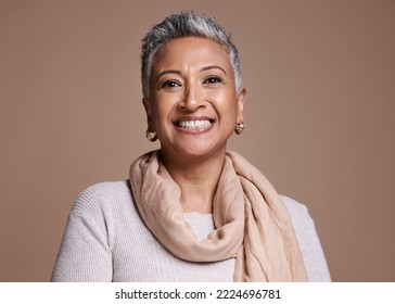 Face, fashion and beauty with a senior woman in studio on a brown background to promote contemporary style. Portait, fashionable and trendy with a mature female posing to model a clothes brand