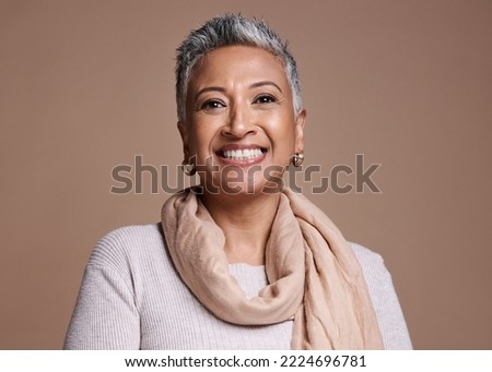 Face, fashion and beauty with a senior woman in studio on a brown background to promote contemporary style. Portait, fashionable and trendy with a mature female posing to model a clothes brand