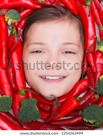 Face funny Boy with Chili Pepper and broccoli looking at camera. Eco Food