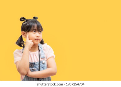 The Face Funny Child Asia Girl Or Teenage, Long Black Hair, White Skin, And Black Eyes. Age 7 Years Old, Cheerful And Smile In The Yellow Full Background,space