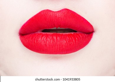 Face of a girl close-up. Red beautiful lips.