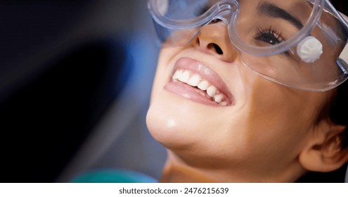 Face, goggles and smile with woman at dentist for oral hygiene or dental care appointment closeup. Checkup, healthcare and medical with happy patient in chair at clinic for mouth cleaning or exam - Powered by Shutterstock