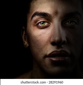 Face Of Handsome Man With Green Eyes In The Shadow