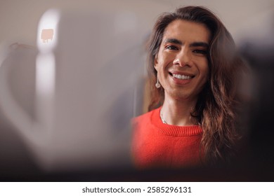 Face of happy non-binary person while doing their job looking at camera