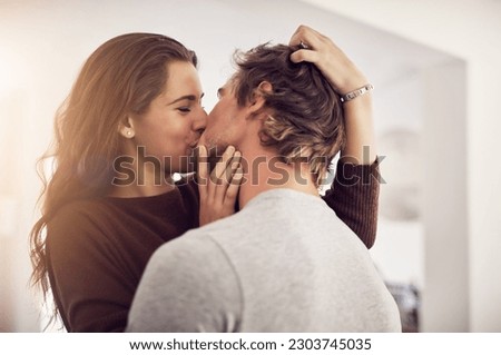 Face of happy woman, man and kiss with love in apartment for romance, intimacy and special moment together. Young couple kissing in home for romantic relationship, happiness and passionate partner