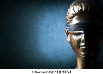 Face of Lady Justice in dark grunge blue background