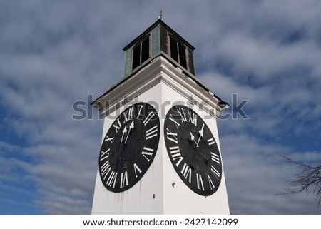 The face of the large white clocktower in Novi Sad, Serbia