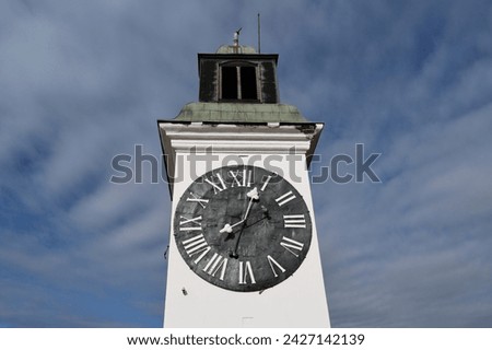 The face of the large white clocktower in Novi Sad, Serbia