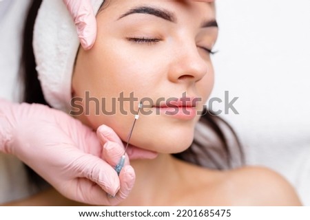 Face lifting PDO Suture operation. innovative technique of New thread lift, cosmetologist preparing to do procedure to female client, select the appropriate thread option