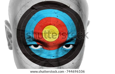 Face of a man with a bulls eye target on his forehead for the concept: Marked man. Double exposure process.