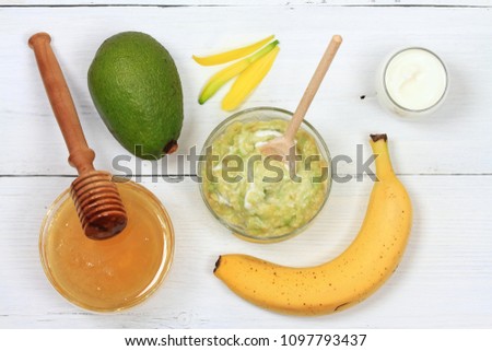 Face mask from avocado, yogurt, banana  and honey. Ingredients for facial mask on the white wooden board, top view