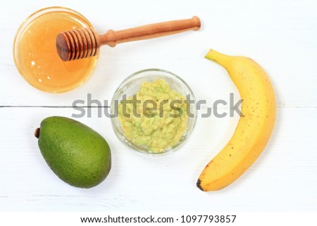 Face mask from avocado, yogurt, banana  and honey. Ingredients for facial mask on the white wooden board, top view