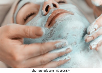 Face mask. Beautiful woman at spa salon, Cosmetician woman applying facial mask. - Powered by Shutterstock