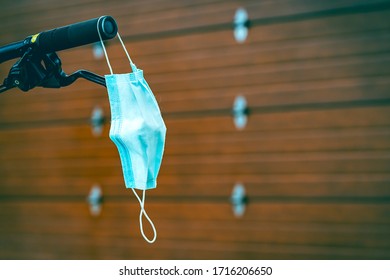 Face mask for coronavirus protection (covid 19) hung at the helm of a bicycle - Powered by Shutterstock