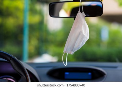 Face Mask Hung In Car's Rear-view Mirror