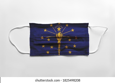 Face mask with Indiana flag printed, on white background, isolated safety concept