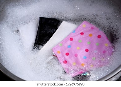 A Face Mask Made Of Fabric Is Being Washed For Cleaning And Reuse.